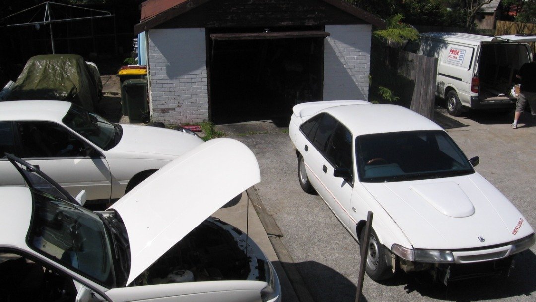 The good old days 3 commodores a 1600 ute under the tarp a S13 Silvia drift car on the street and i am pretty sure i hav