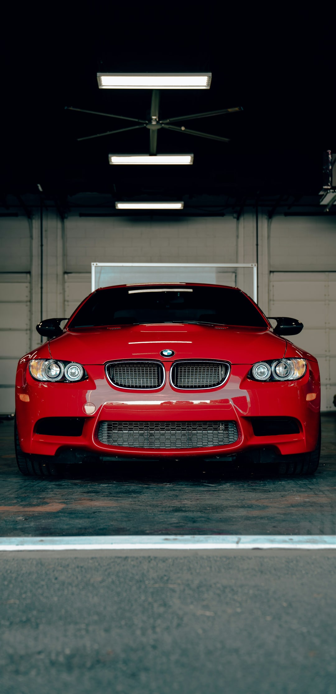 Red E92 M3 in a workshop with the lights on, looking like it knows exactly what it is. Not a school run car. I have run