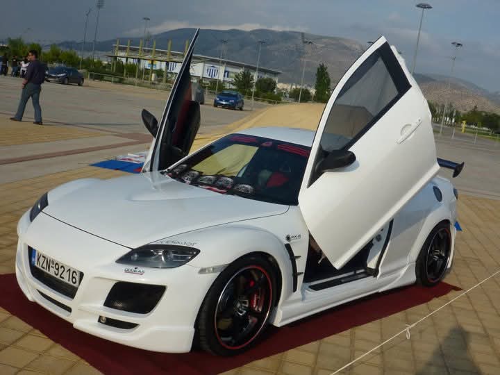I hated this Lambo door trend that took over like 20 years ago. #oldphotos #athens #mazda 
  Mazda RX8 FE